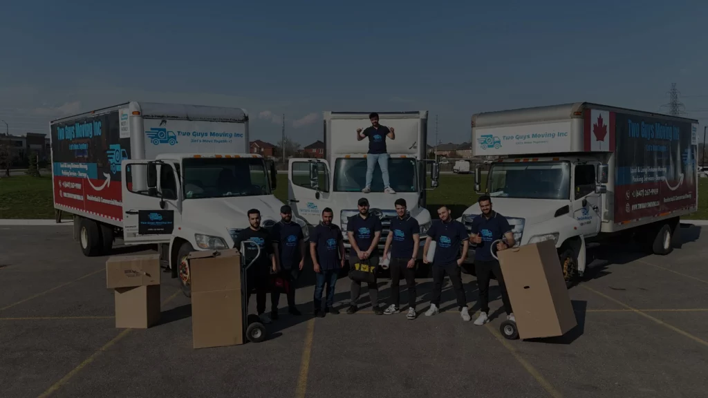 Two Guys Moving Team with moving company trucks behind them